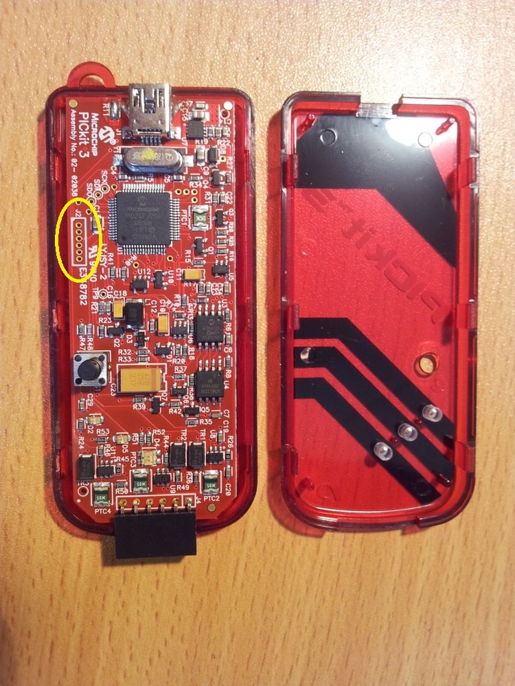 Opening up the bricked PICkit3. The programming header we are interested in (J2) is circled in yellow.