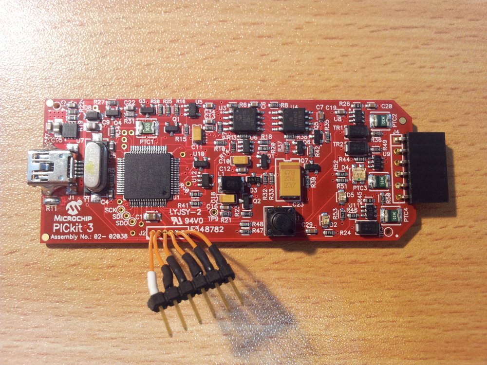 Soldering on a 6-pin 2.54mm header to J2 on the bricked PICkit3. If you make the wires short enough, you can leave this header on and fit it back into the enclosure without any problems.