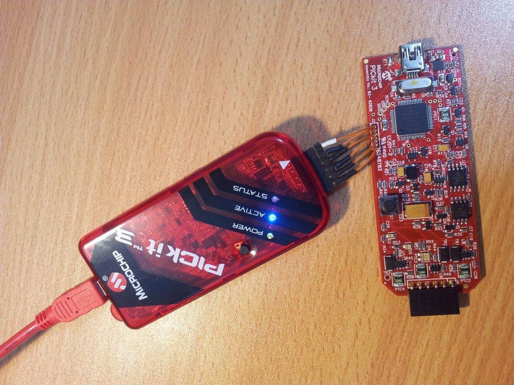 Connecting up a working PICkit3 to the bricked PICkit3. Notice the polarity of the white arrow on the working PICkit 3 with the notch on J2.