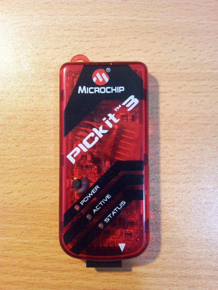 Putting the now un-bricked PICkit3 back into it's enclosure, with the programming header still attached (it fits quite nicely).